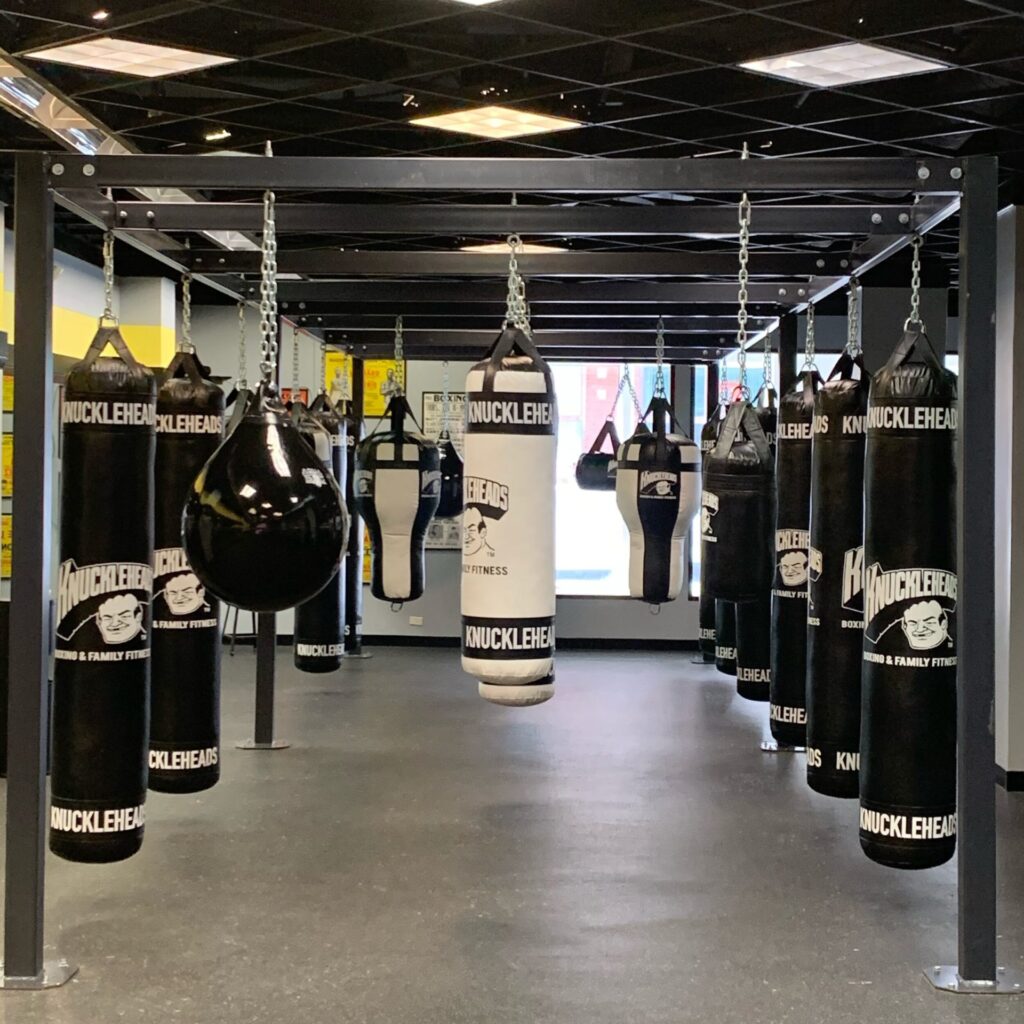 Wide shot of gym with different types of heavy bags.